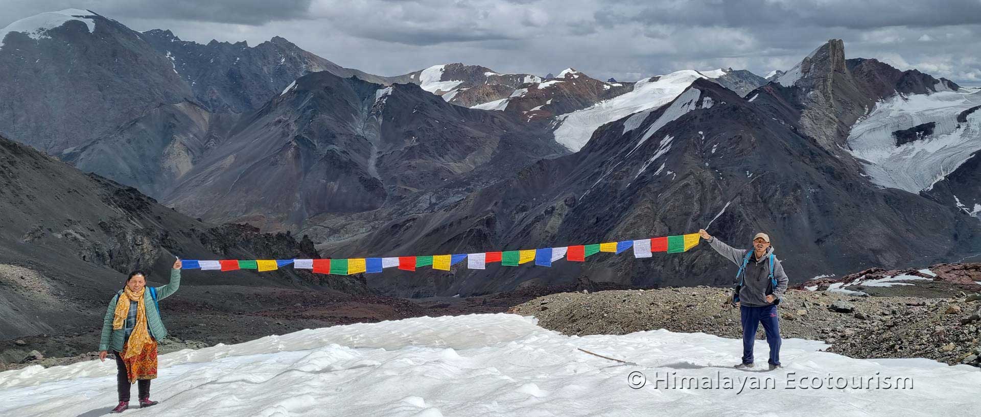 Placing prayer flags on the Tso Marpo trek, Zanskar, Ladakh